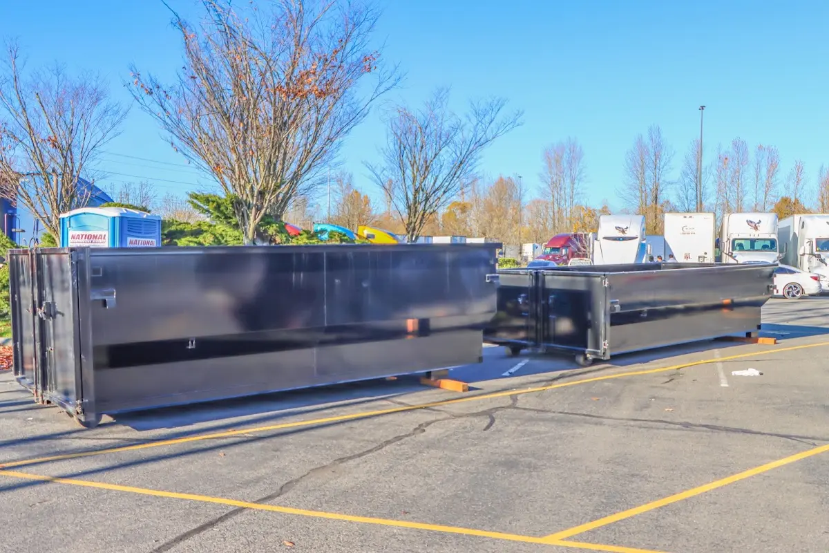 Professional dumpster rental service with roll-off container on residential driveway in Jericho